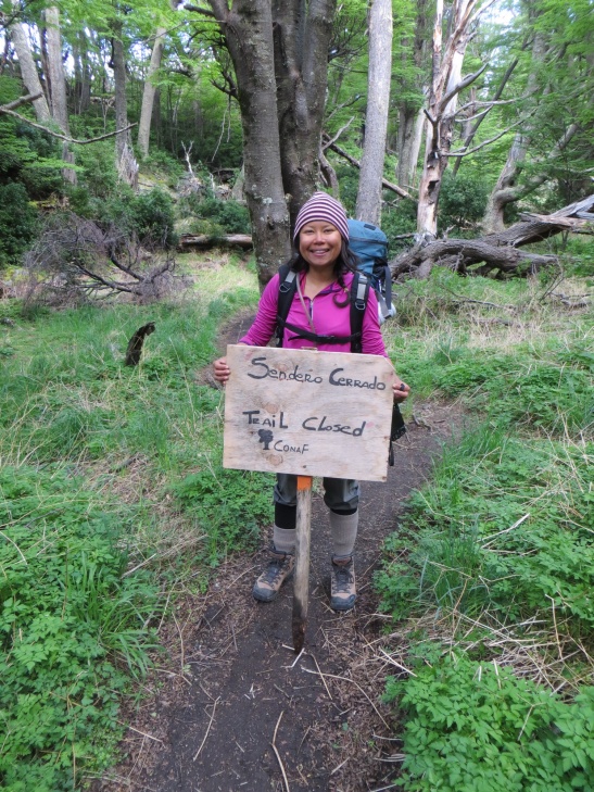 Rodora holding up the trail closed sign.
